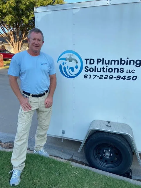 Terrill Dobbs, owner and master plumber, beside the TD Plumbing Solutions trailer